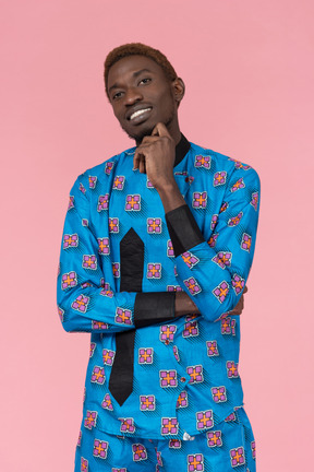 Black man in blue pajamas smiling