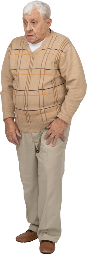Front view of an impressed old man in casual clothes