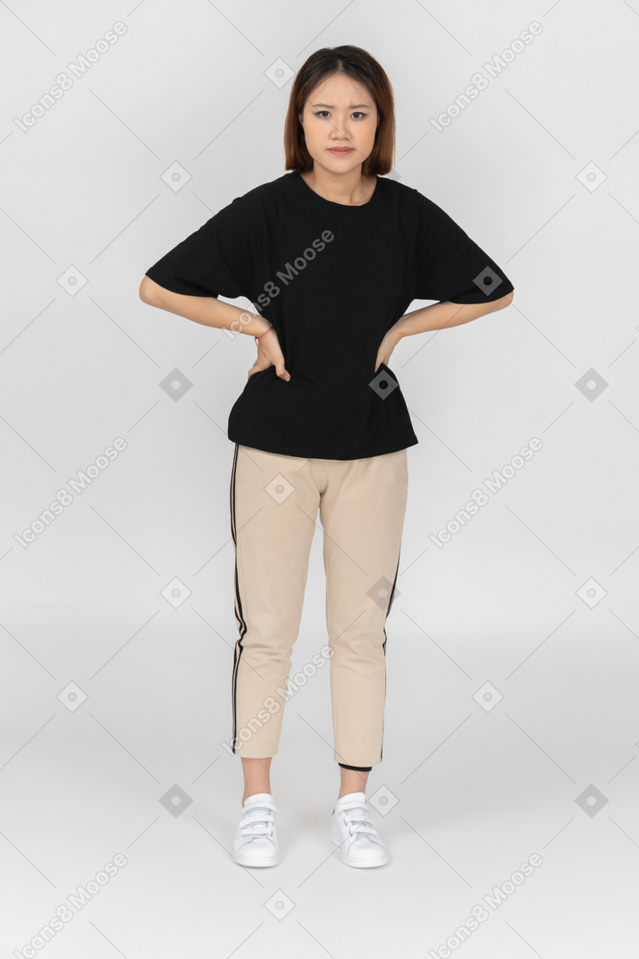 Concerned young woman with hands on her hips