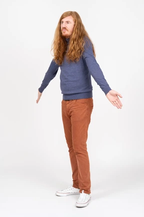 Side view of a young man standing with outstretched arms