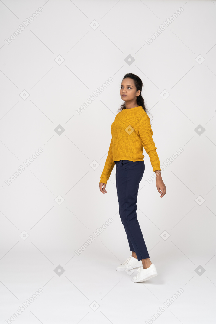 Side view of a confused girl in casual clothes looking up