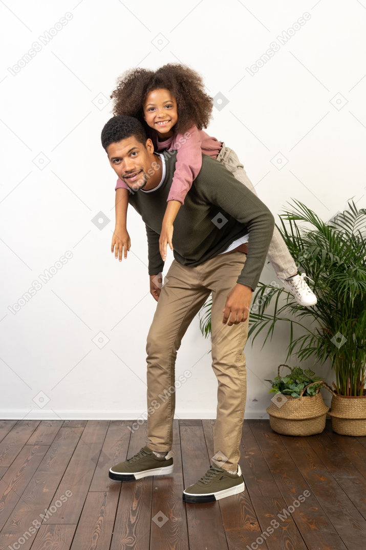 Good looking young man playing with a girl