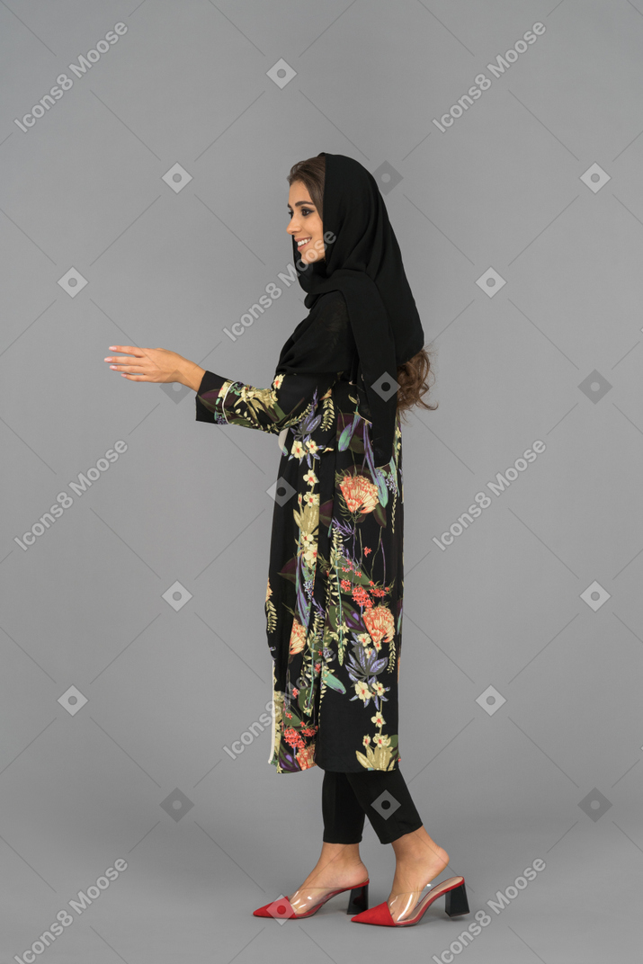 Smiling arab girl is about to shake hands