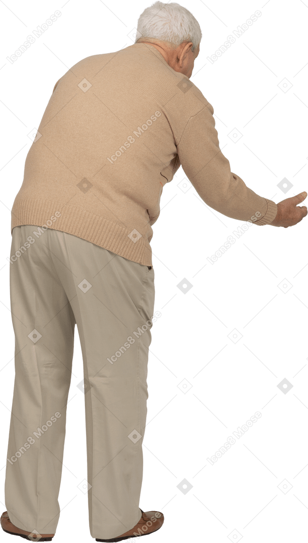 Rear view of an old man in casual clothes bending down with outstretched arm