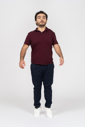 Man in casual clothes standing on tiptoe