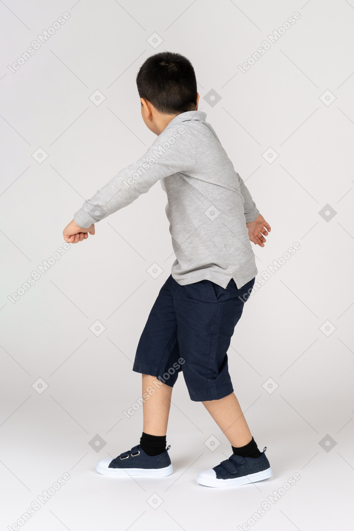 Rear view of a boy in fighting stance