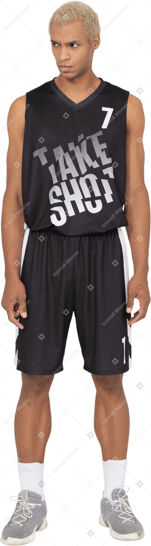 Front view of a young male basketball player standing with his head down