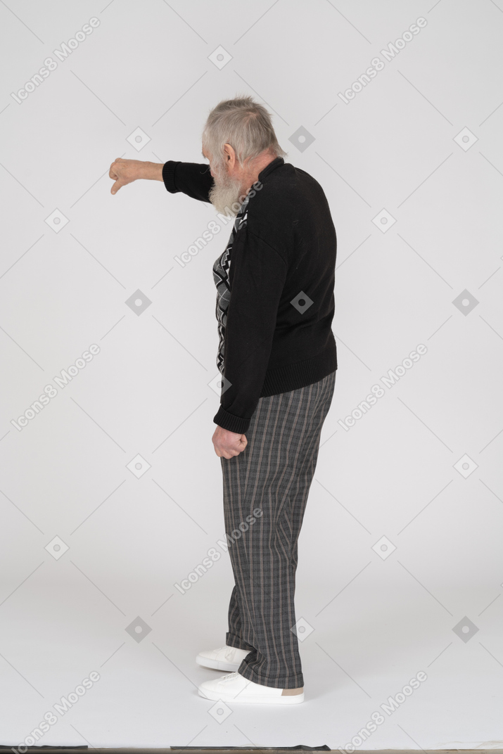 Back view of old man giving thumbs down