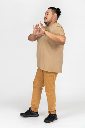 Young asian man showing heart figure with his fingers
