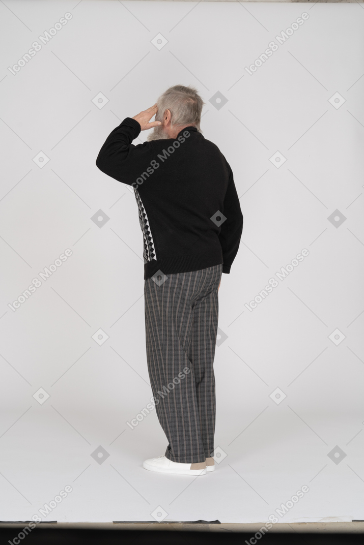 Rear view of saluting old man