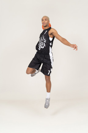 Front view of a young male basketball player scoring a point