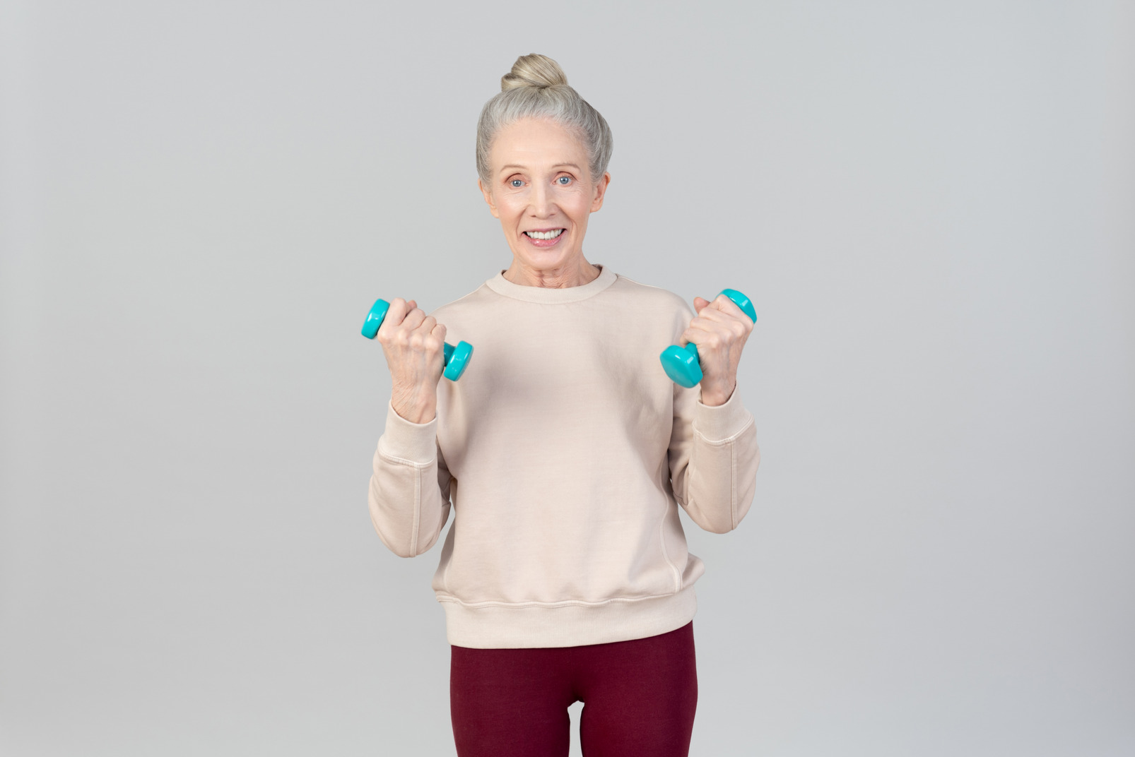 Old woman holding hand weights