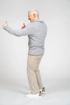 Side view of man giving thumbs up with two hands