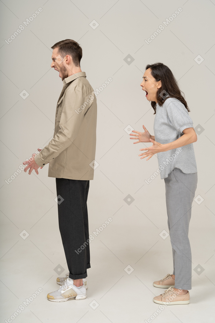 Side view  of young couple being mad and shouting