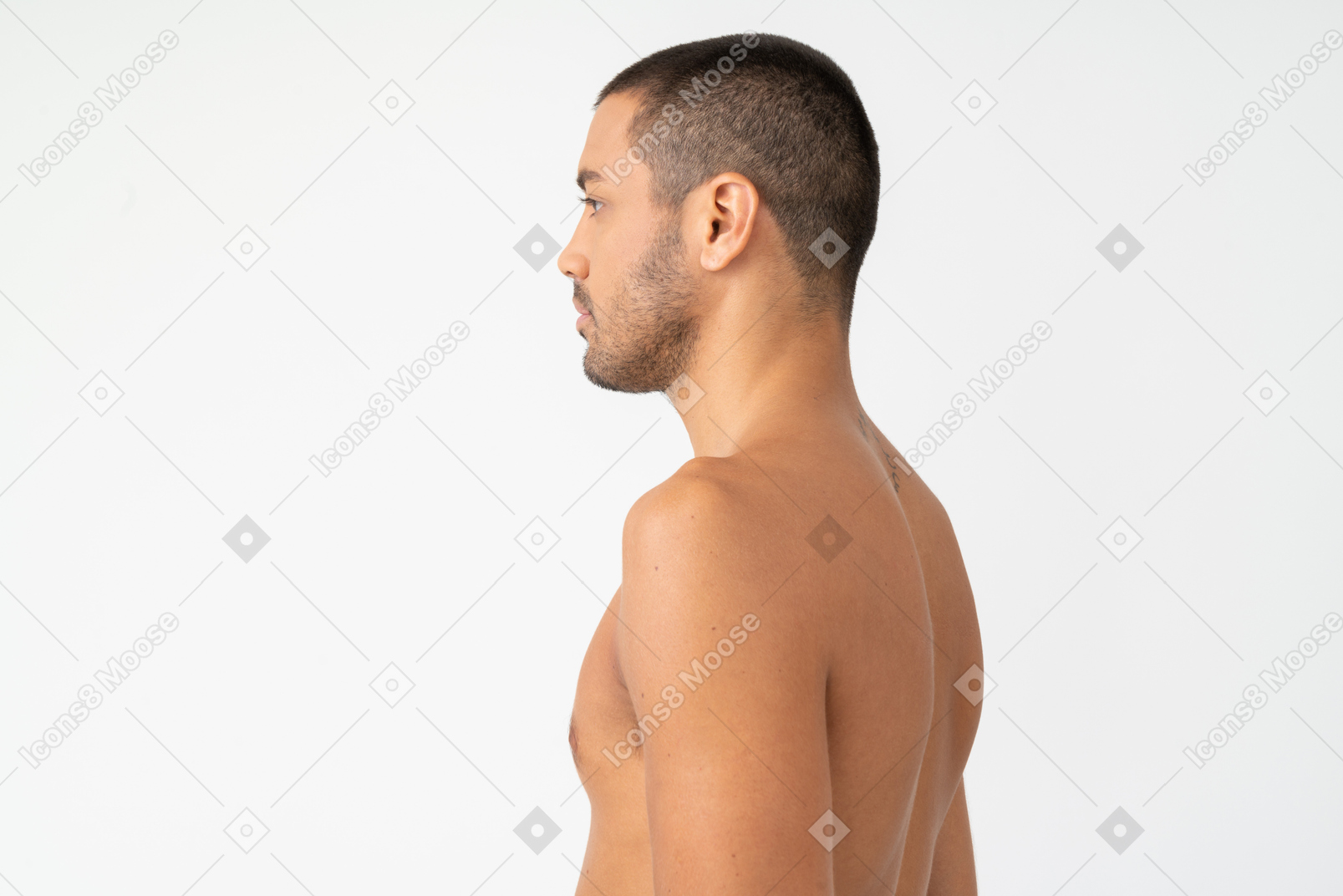 Barechested young man standing in profile