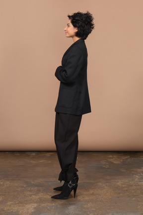 Side view of a pleased businesswoman in a black suit