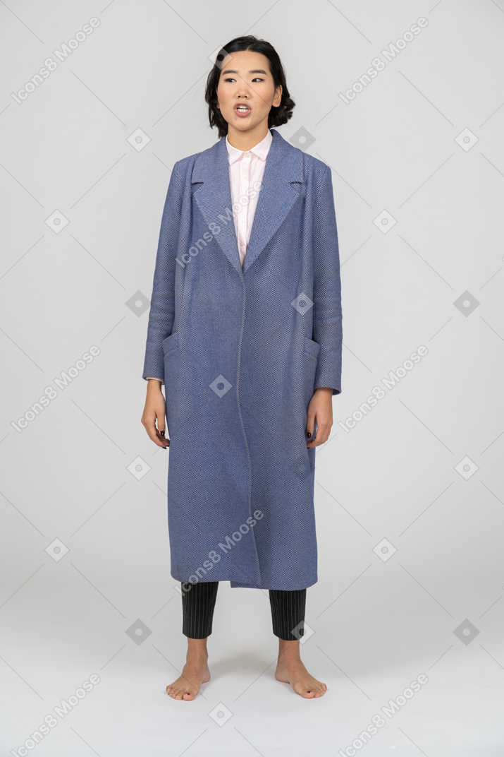 Front view of a woman in blue coat talking