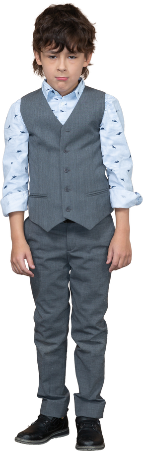 Front view of a boy in grey suit standing still