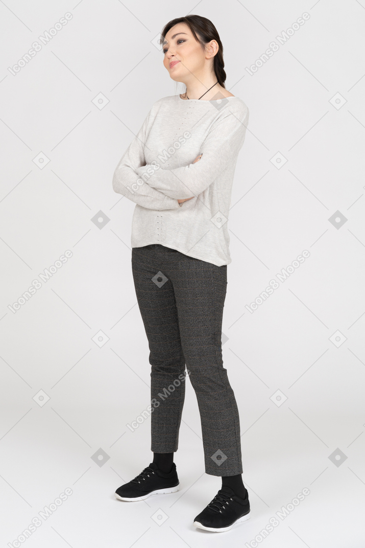 Skeptic young female posing with folded hands