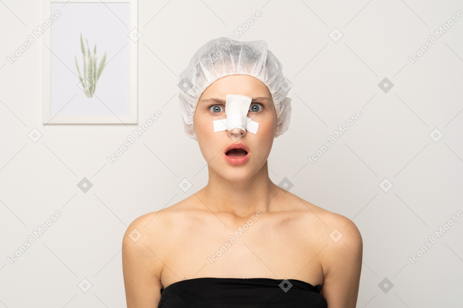 Shocked female patient with bandage on her nose