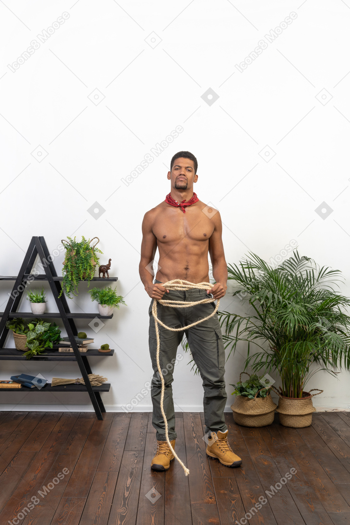 Good looking athletic man with the rope