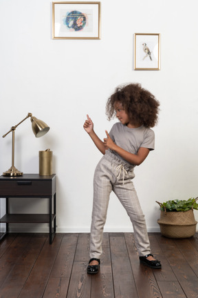 Good looking girl kid posing on the apartment background