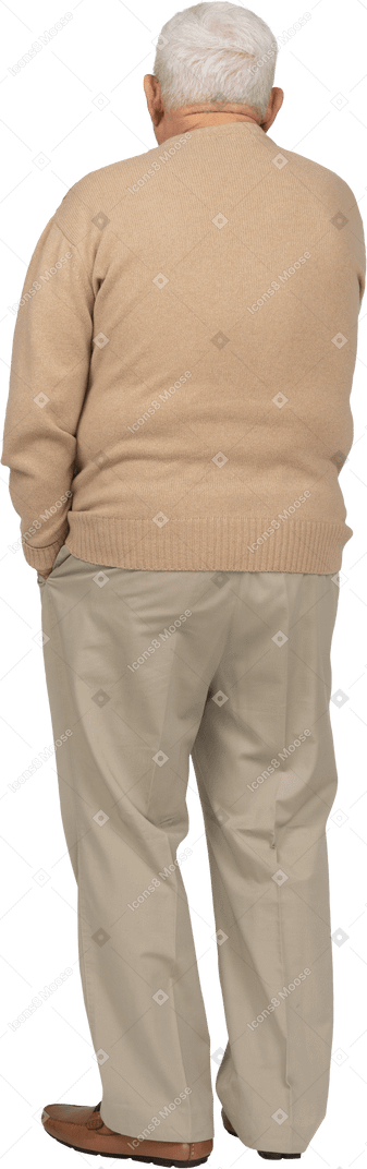 Rear view of an old man in casual clothes standing with hand in pocket