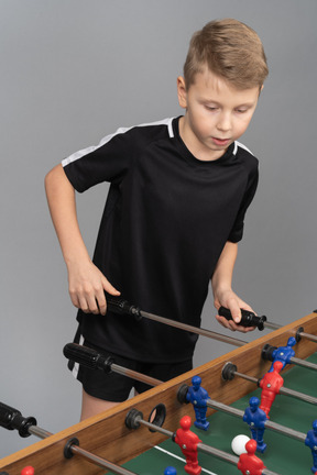 Close-up of a boy playing foosball