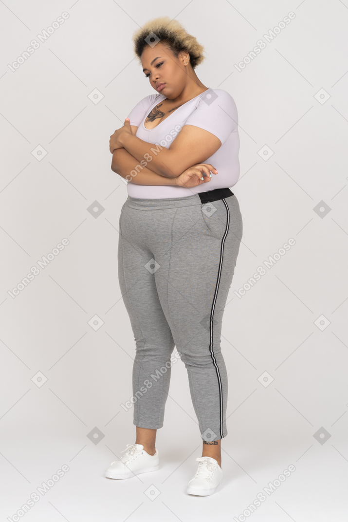 Offended dark skinned female posing with folded arms