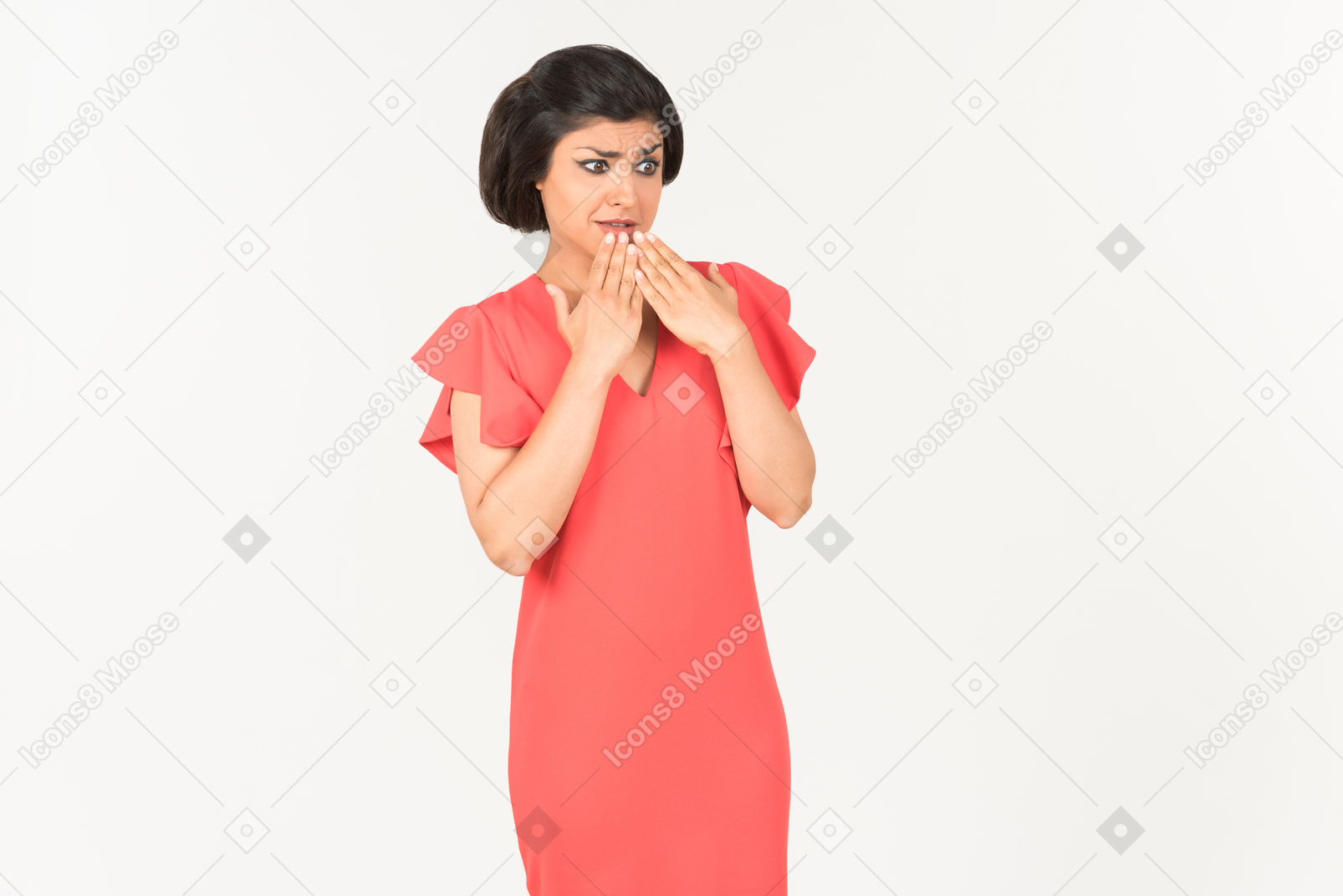Slightly shocked looking young indian woman almost closing her mouth with hands