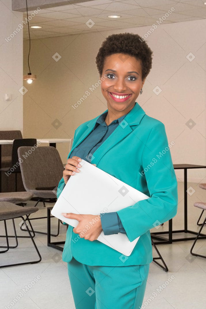 A woman in a suit holding tablet in the office