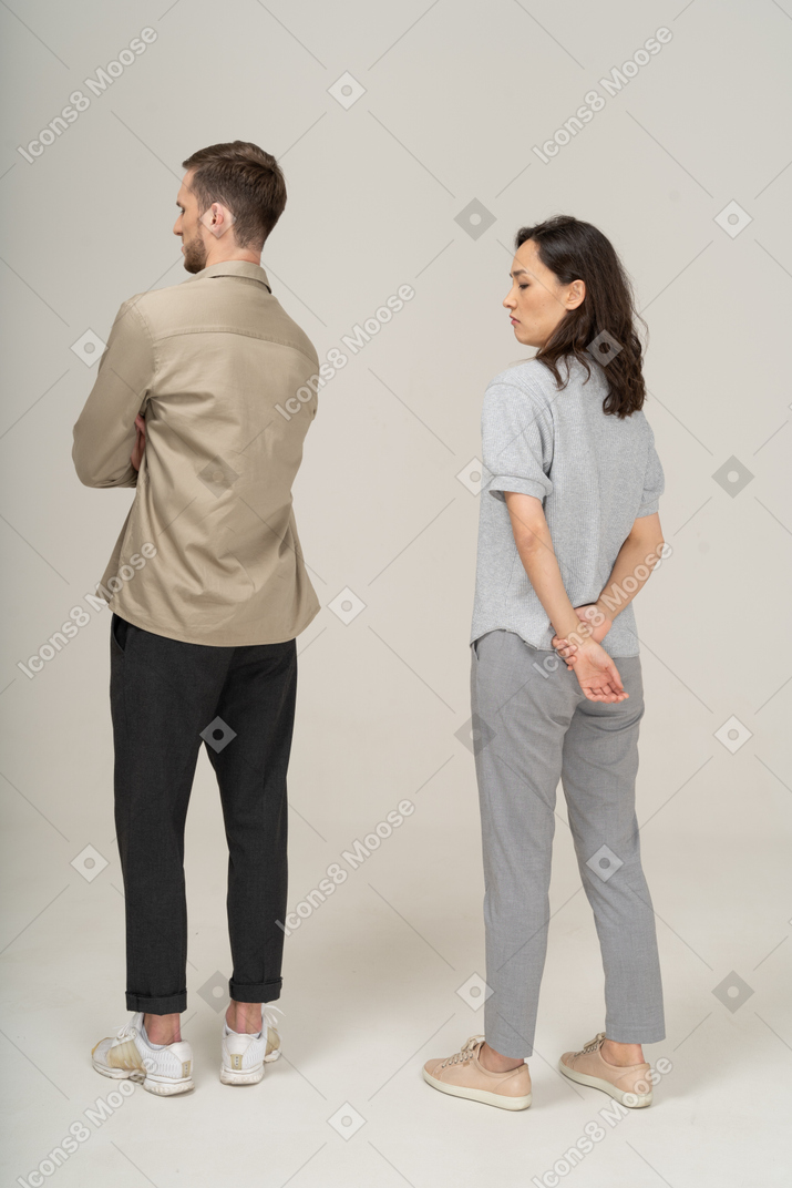 Three-quarter back view of young couple being squeamish
