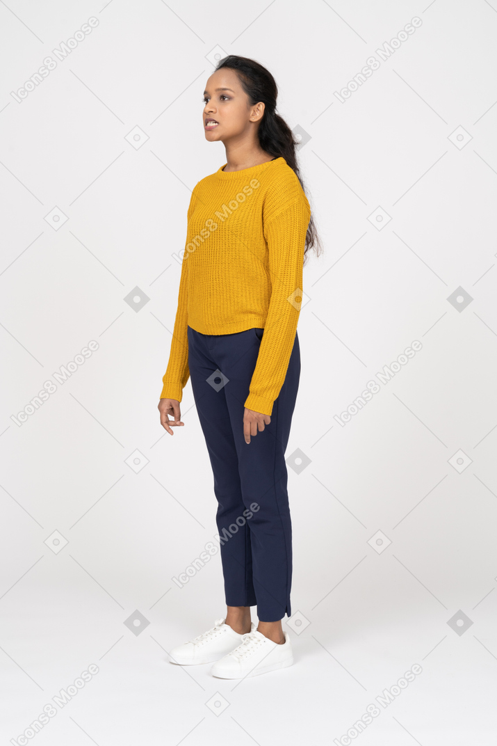 Side view of a girl in casual clothes making faces