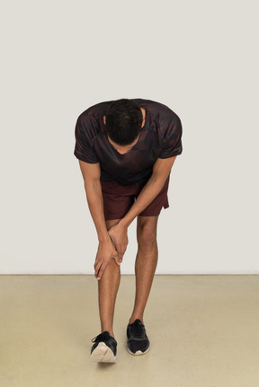 Young man in sports clothes exercising