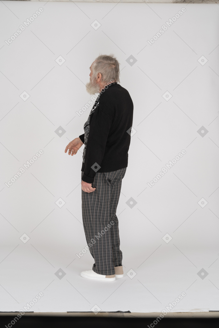 Side view of old man with raised hand