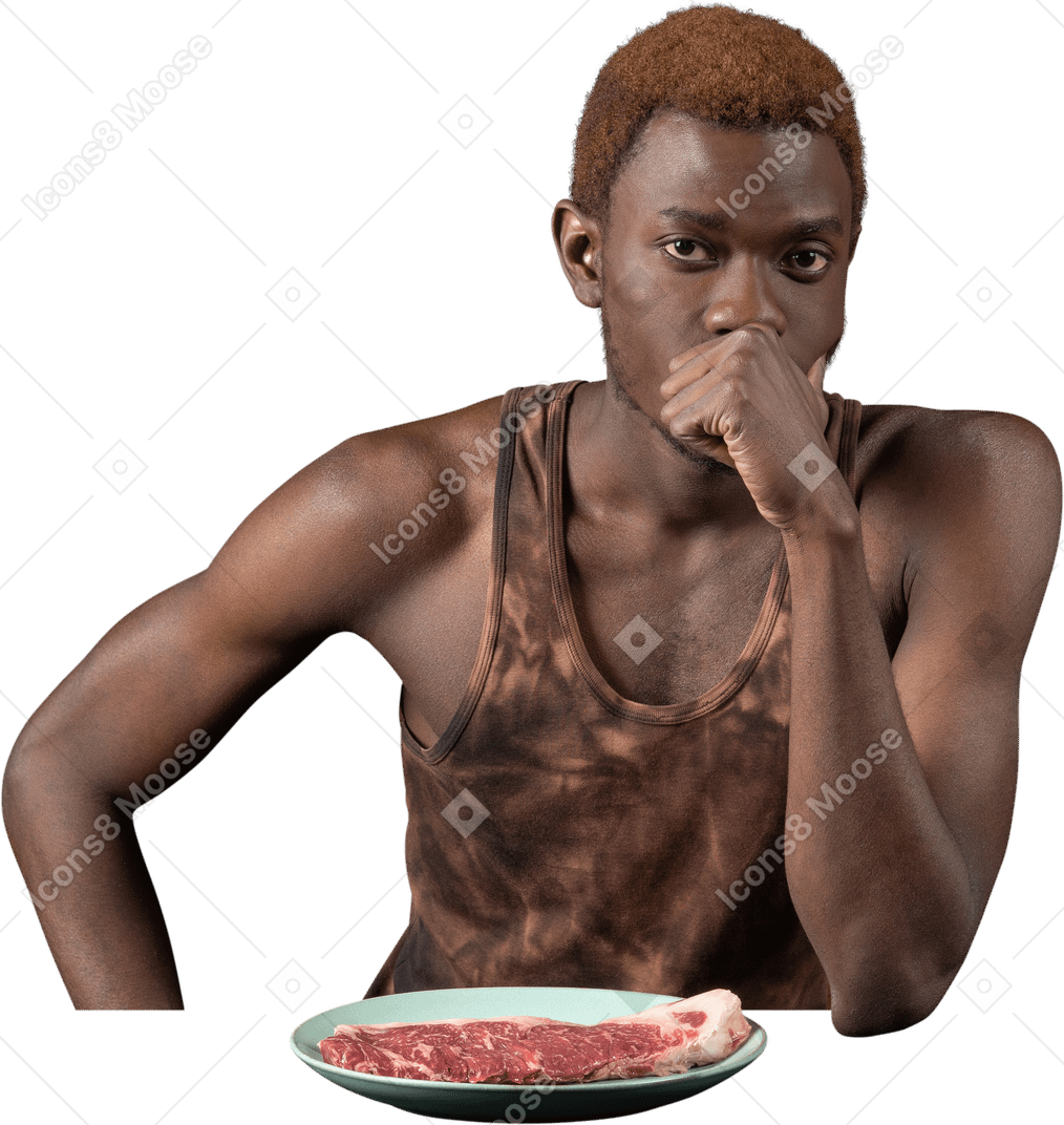 Vorderansicht eines nachdenklichen jungen afro-mannes, der am tisch sitzt