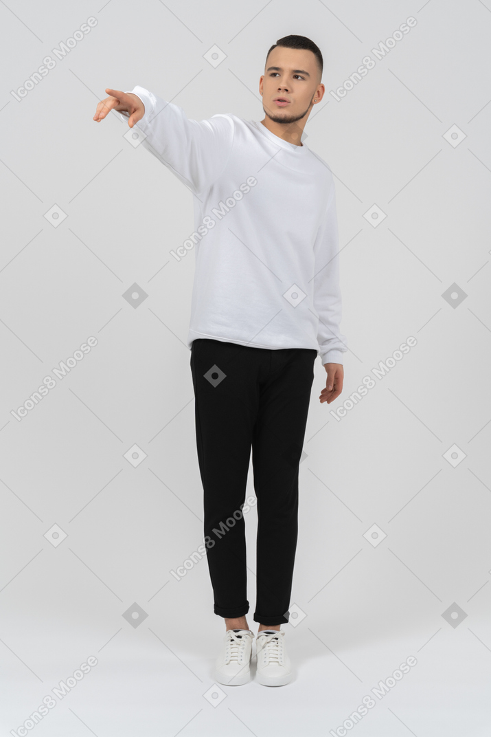 Young man pointing at something