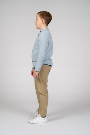 Boy in casual clothes standing in profile