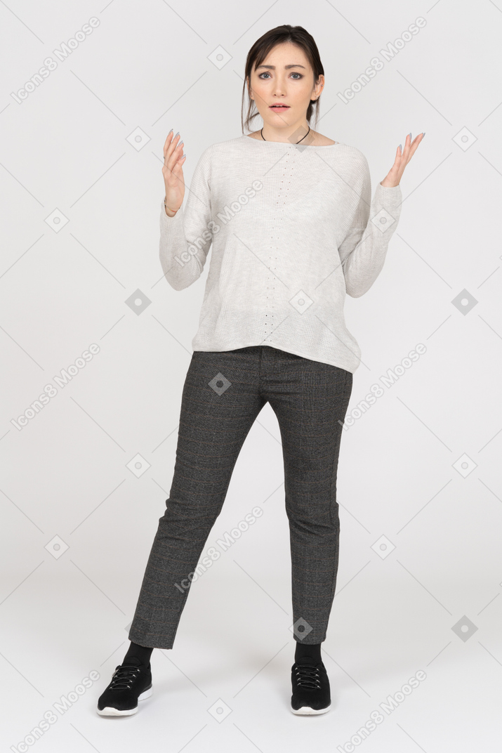 Confused woman appealing to camera with both hands
