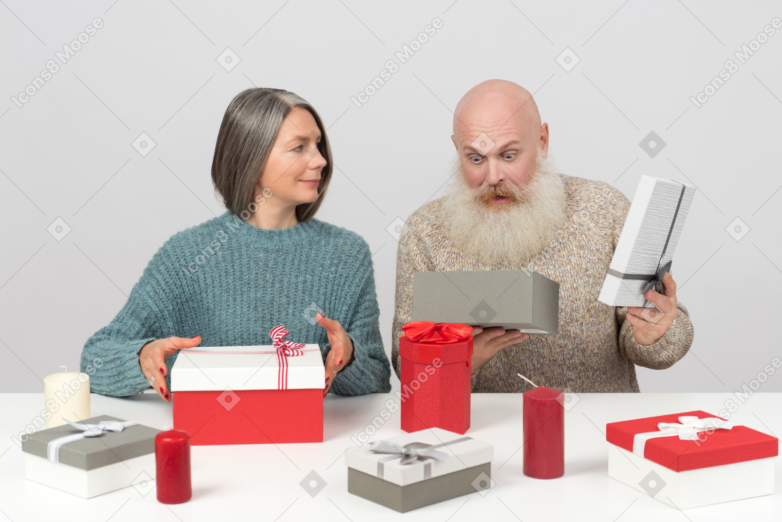 Elegant elderly couple unpacking christmas gifts