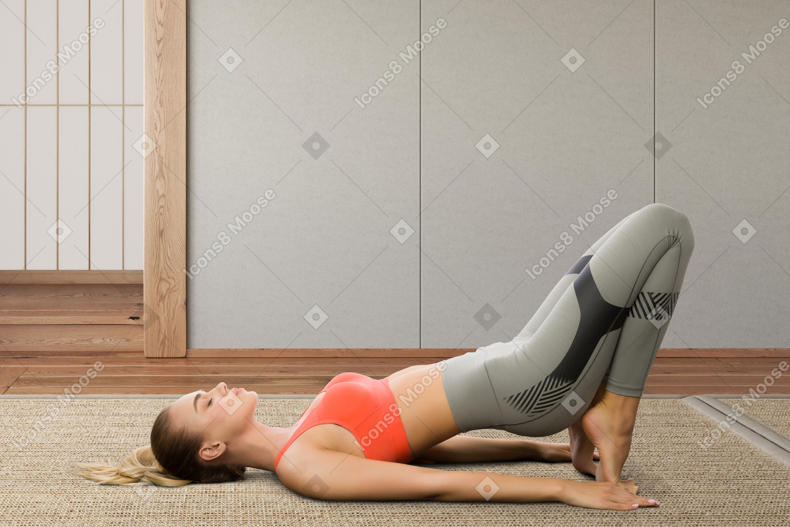 A woman is doing a yoga pose on the floor