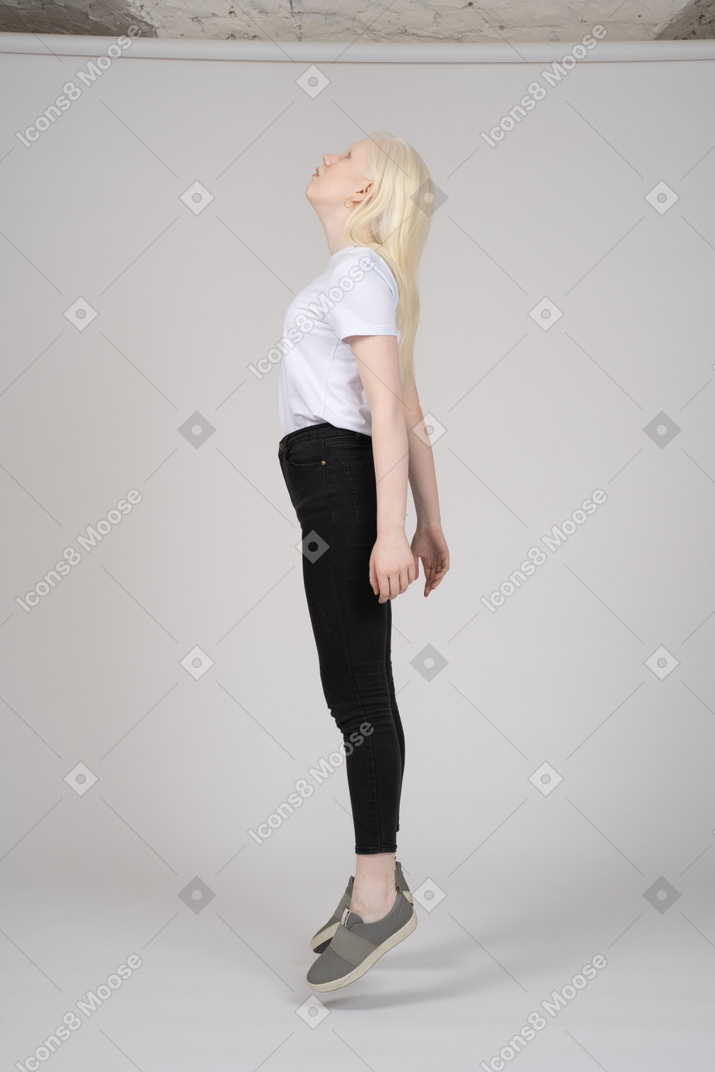 Side view of girl levitating