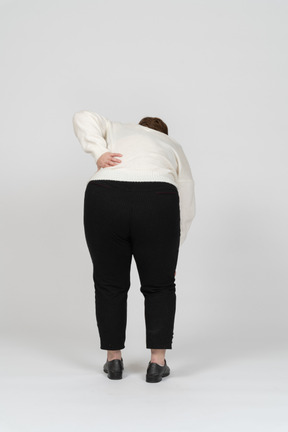 Mulher gorda sofrendo de dores na parte inferior das costas