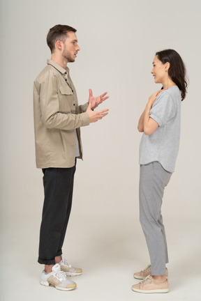 Side view of young couple speaking to each other