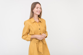 Smiling young caucasian woman in yellow dress
