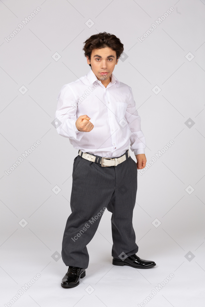 Businessman standing with fist clenched