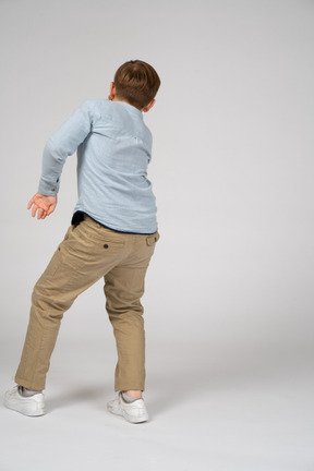 Back view of a boy in blue shirt