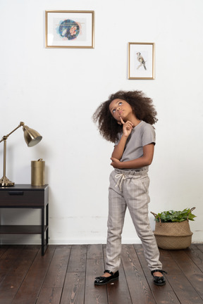 Good looking girl kid posing on the apartment background