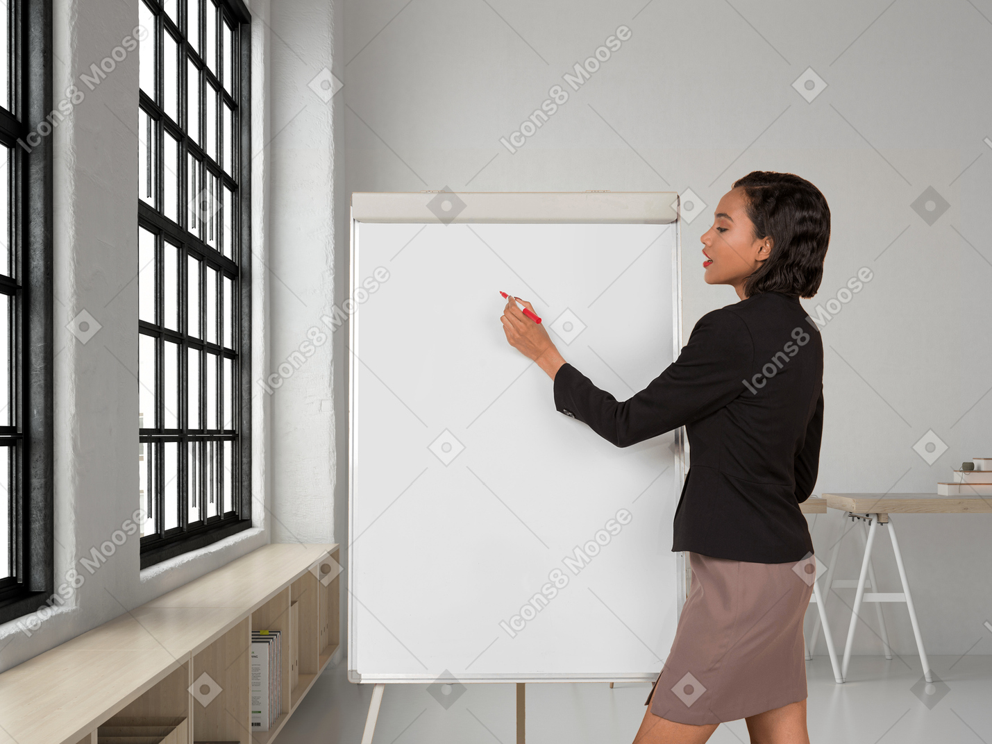 A business woman writing on a whiteboard in an office