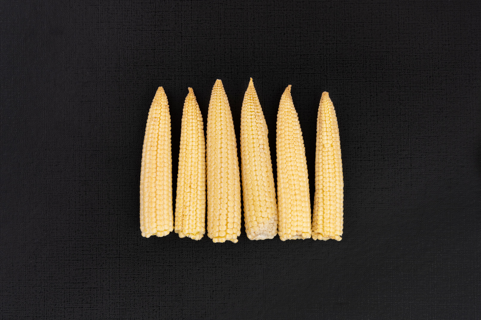 Baby corns on black background